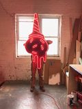 A man holding a large neon ice cream cone