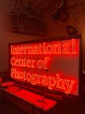 Neon sign with skeleton hand a hand high fiving, with Namaste underneath